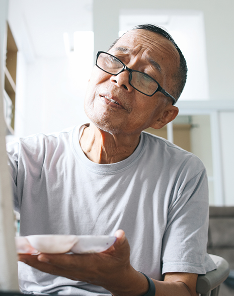 Contemplative man painting on a canvas