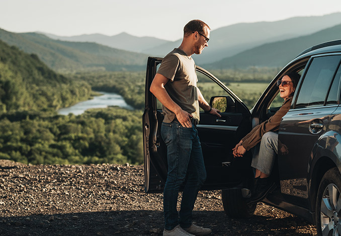 Couple talking by car