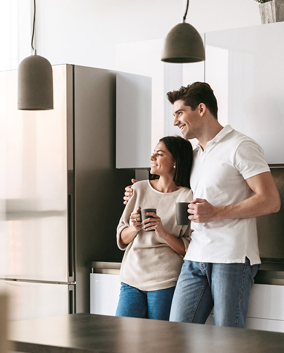 Couple standing in their home kitchen