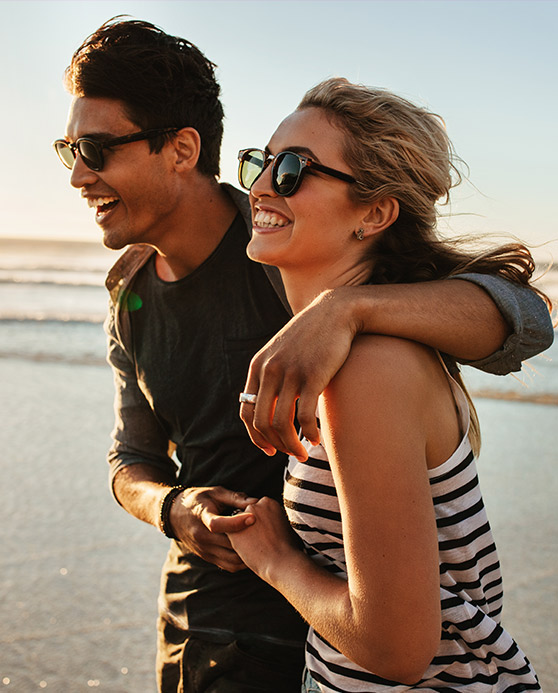 Couple embracing while walking on the beach