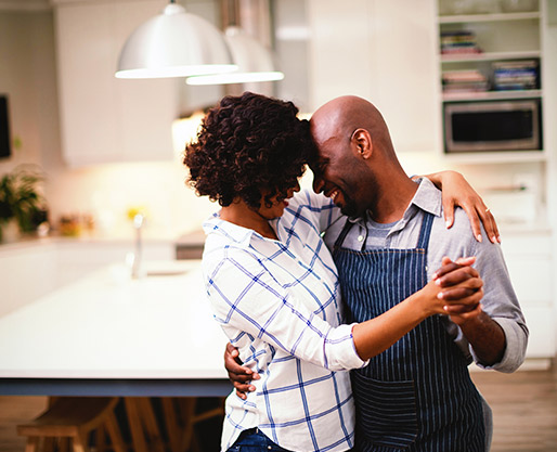 Couple dancing romantically in their kitchen