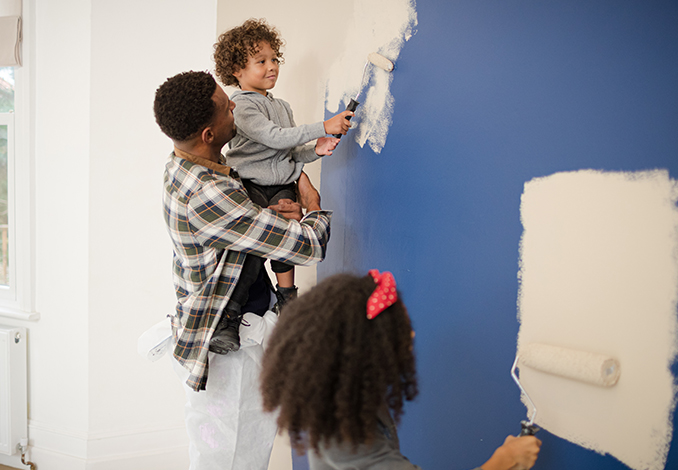 Family painting wall together