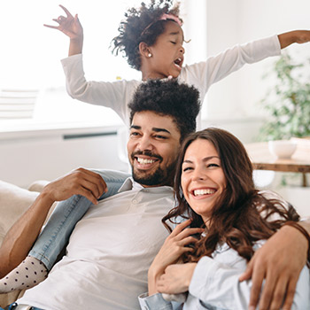 Happy family sitting together on a couch