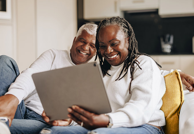 Smiling couple using an ipad