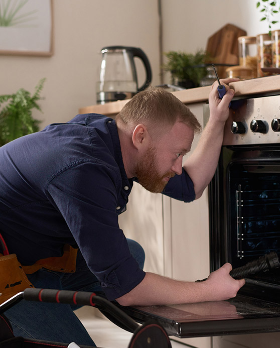 Home inspector looking into an oven