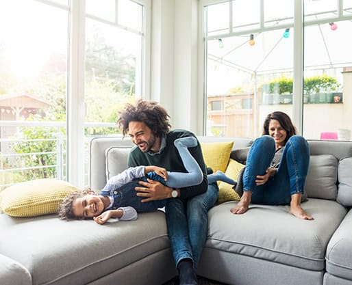 Family playing on couch.