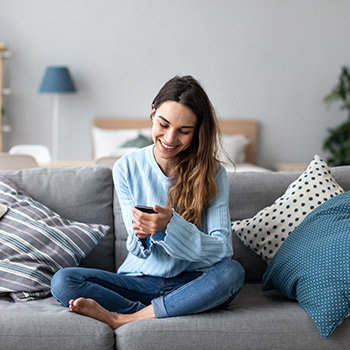 Woman wearing blue sitting on couch