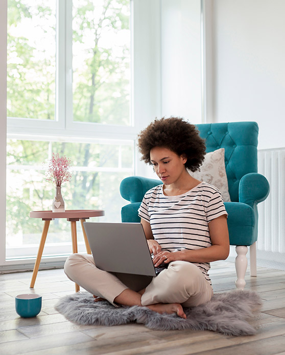 Woman sitting on the floor in her new living room
